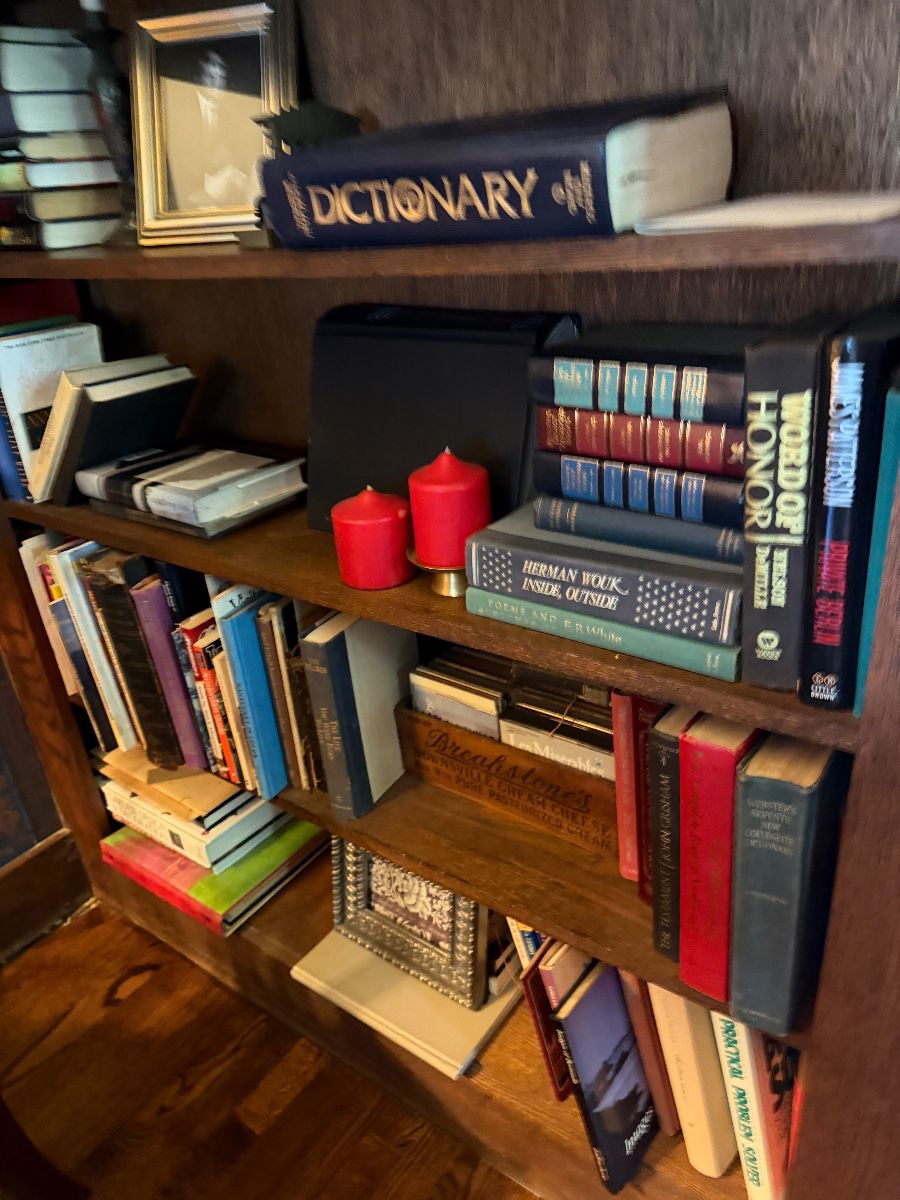 Shelves of books and small collectibles at the Caldwell estate sale